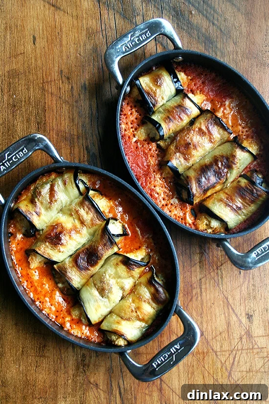 Two pans of perfectly cooked eggplant involtini, ready to serve.