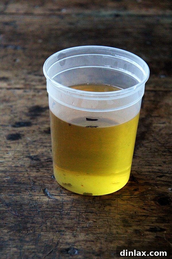 Two measuring cups, one showing the initial amount of frying oil and the other the significantly reduced amount after frying, illustrating minimal oil absorption.