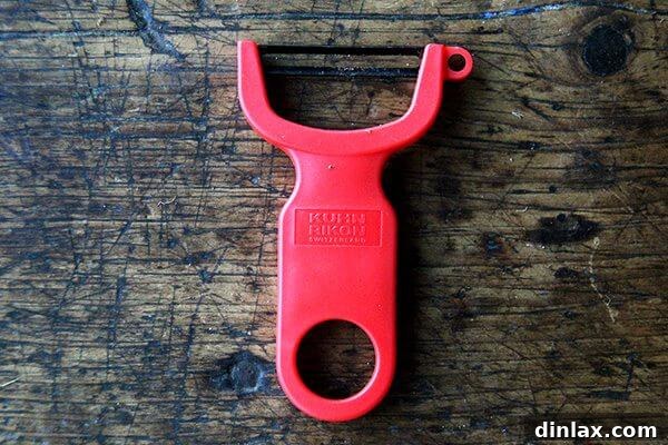 A vibrant green Kuhn Rikon peeler, a simple yet essential kitchen tool.