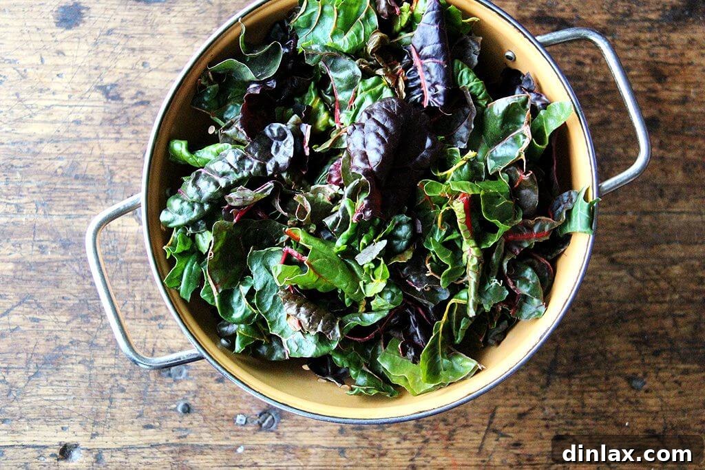 Fresh, vibrant green Swiss chard leaves, ready for cooking.