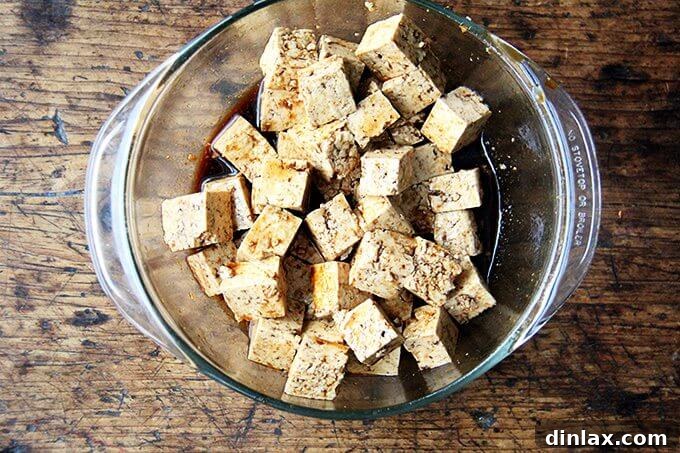 Close-up of baked tofu cubes, golden brown and perfectly firm for the stir-fry.