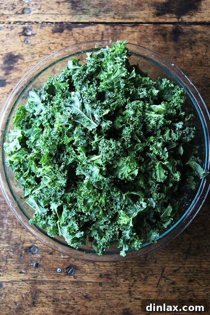 Freshly prepared ingredients for the vegan kale Caesar salad, featuring thinly sliced red onions soaking in vinegar.
