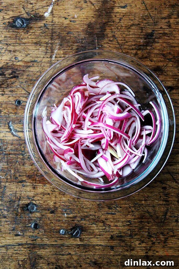 Close-up of curly kale leaves being prepared for massaging, highlighting their vibrant green color.