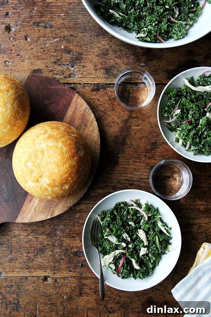 A serving of the vegan kale Caesar salad, showing the tender kale leaves, red onions, and pumpkin seeds, perfect for a healthy lunch.