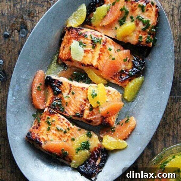 A dazzling sizzle platter presenting broiled arctic char perfectly dressed in a bright, zesty citrus sauce.