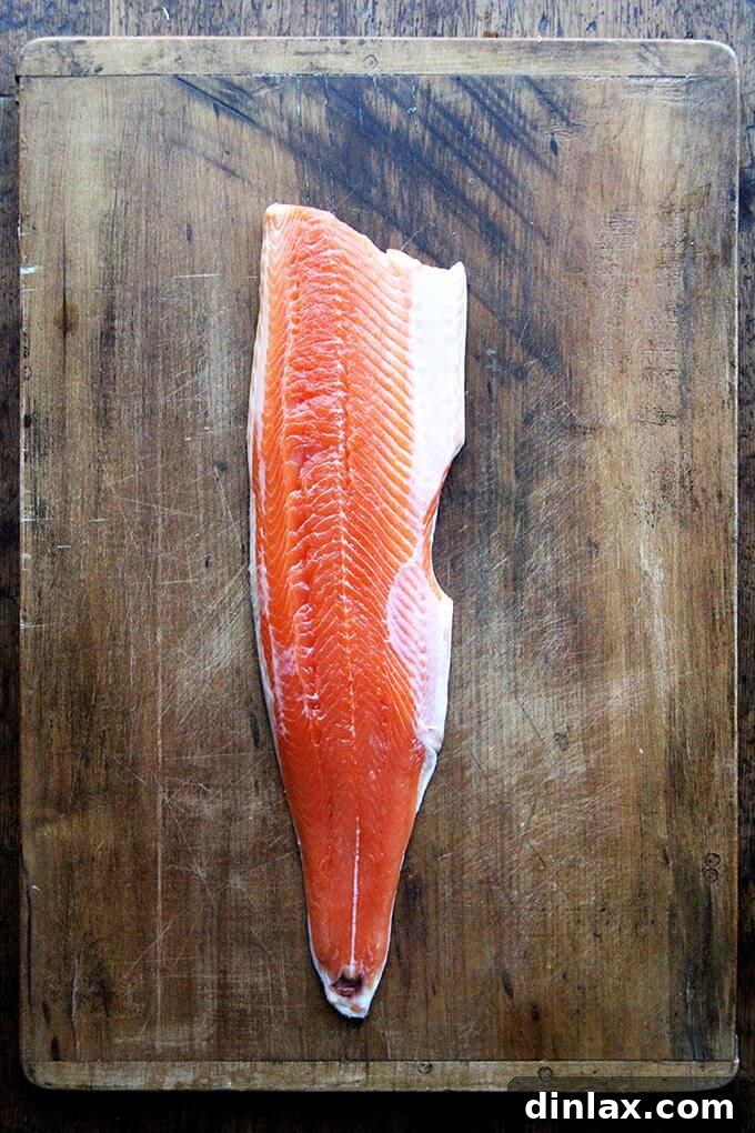 A freshly prepared Arctic Char fillet on a cutting board, ready for the marinade.