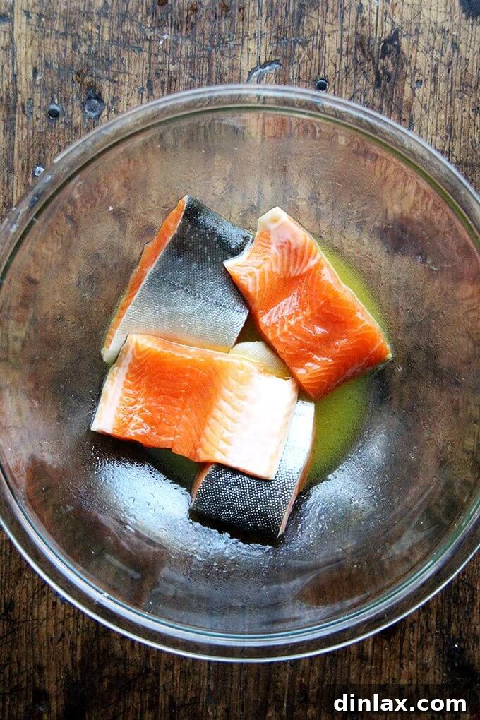 Arctic Char fillets marinating in a sweet and tangy blend of honey, fresh citrus juice, and olive oil.