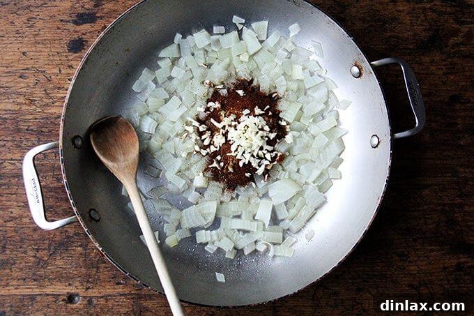 Spiced Chickpea Fiesta Bowls 2 A sauté pan with onions, spices, and garlic.