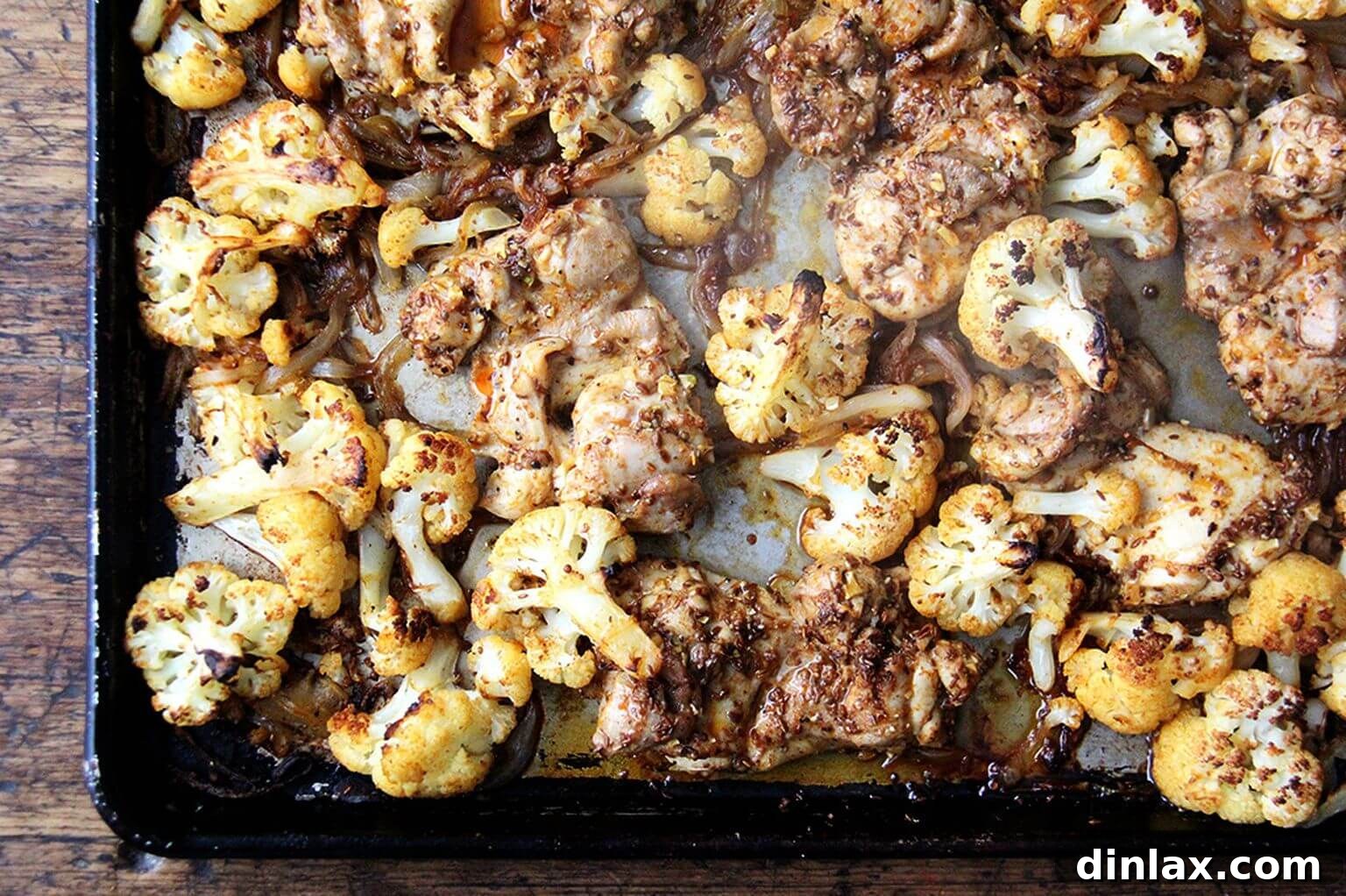 The sheet pan chicken and cauliflower shawarma roasting in the oven, with rich, caramelized edges.