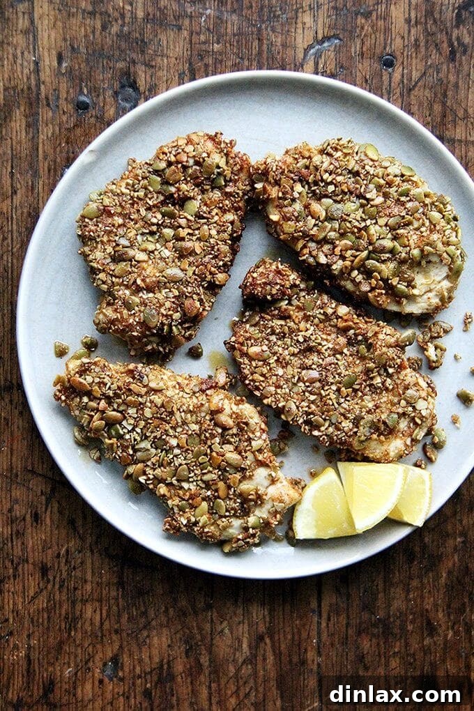 Crispy Pepita-Crusted Chicken Cutlets with a vibrant orange salsa, showcasing the golden-brown crust made from toasted pumpkin seeds and aromatic spices.