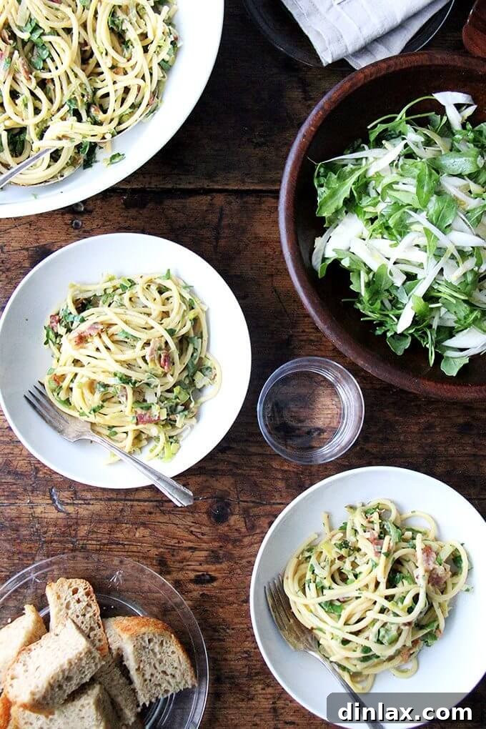A close-up of crispy bacon bits, ready to be added to the carbonara for texture and savory depth.