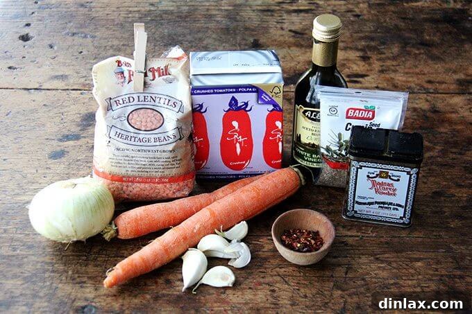 Hearty Golden Chickpea and Lentil Soup 3 All the fresh ingredients laid out for curried chickpea and lentil soup: lentils, chickpeas, diced onions, carrots, garlic, crushed tomatoes, and various spices.