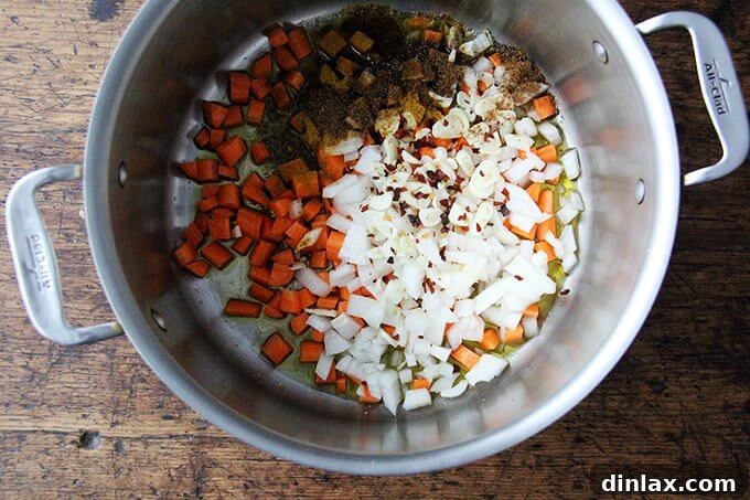 Hearty Golden Chickpea and Lentil Soup 4 Onions, carrots, garlic, and spices sizzling in olive oil in a large pot, releasing their aromatic flavors.