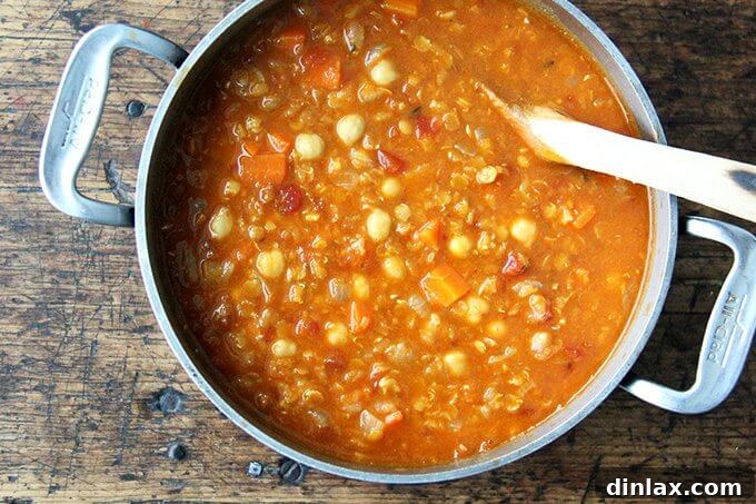 Hearty Golden Chickpea and Lentil Soup 6 All ingredients combined in a pot, simmering gently to allow the flavors to meld and the lentils to soften.