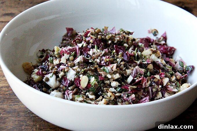 A side view of the robust roasted vegetable and lentil salad, showcasing its layered components.