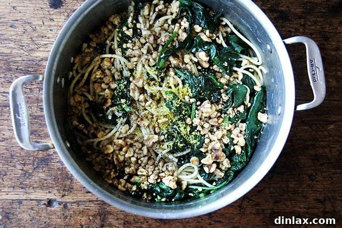 Cooked pasta, spinach, and toasted walnuts tossed with the creamy lemon garlic sauce and fresh lemon zest.