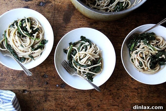 A perfectly plated serving of spring pasta with spinach, walnuts, and lemon, ready to be enjoyed.