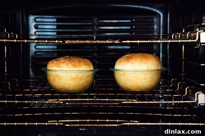 Homemade Bread Made Easy 14 Two loaves of peasant bread baking in the oven, turning golden brown.