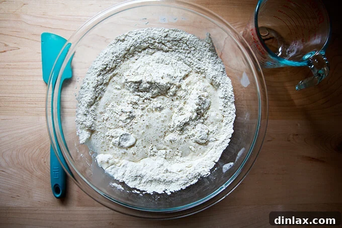 Homemade Bread Made Easy 5 Adding water to the bowl of dry ingredients for the peasant bread dough.
