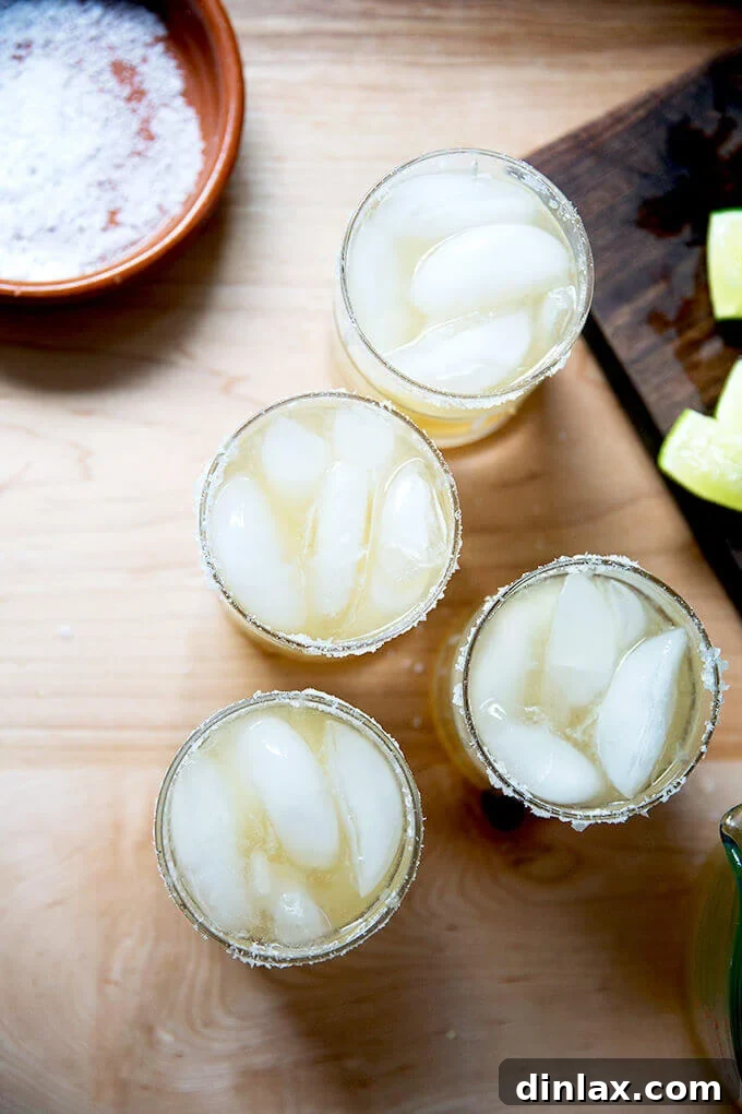 A vibrant, classic margarita cocktail, garnished with a fresh lime slice.