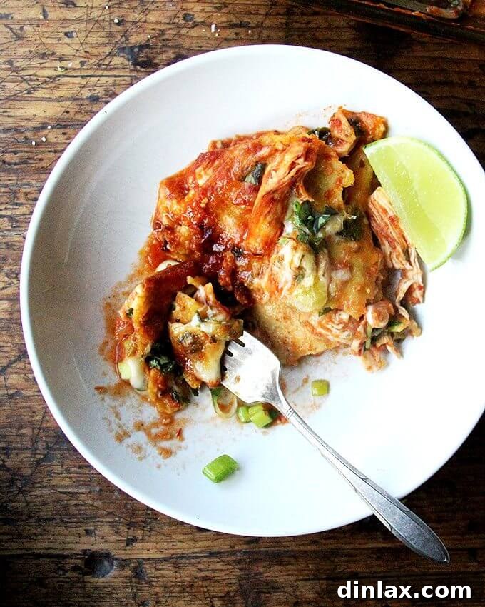 Delicious chicken enchilada casserole, layered like lasagna for an easy, no-fuss meal.