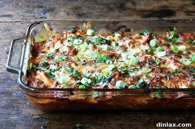 A close-up of a slice of the chicken enchilada casserole, showing the layers.