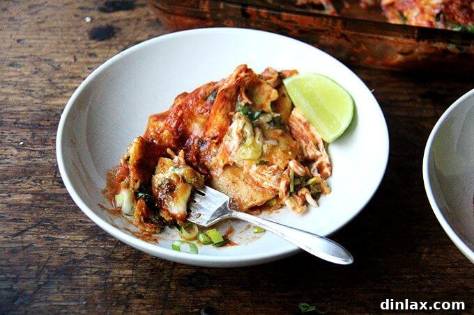 Another perspective of the served chicken enchilada casserole, garnished with fresh herbs.