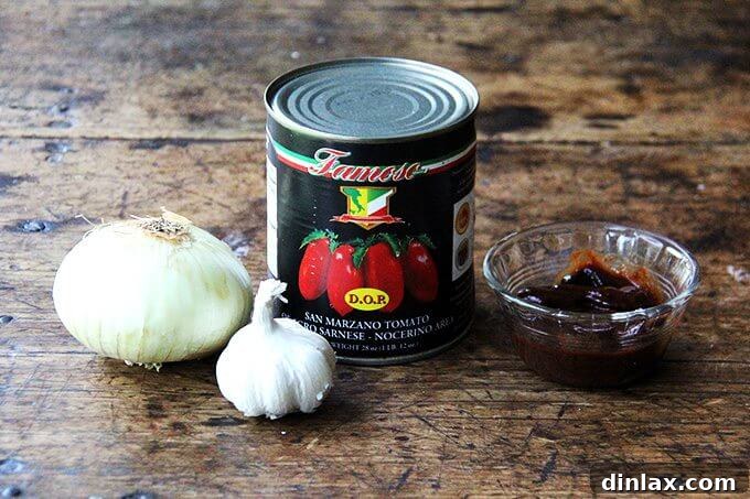 Ingredients laid out for a homemade chicken enchilada sauce.