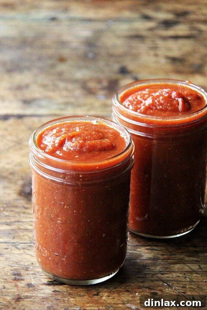Close-up of the smooth, vibrant red enchilada sauce in a pot.