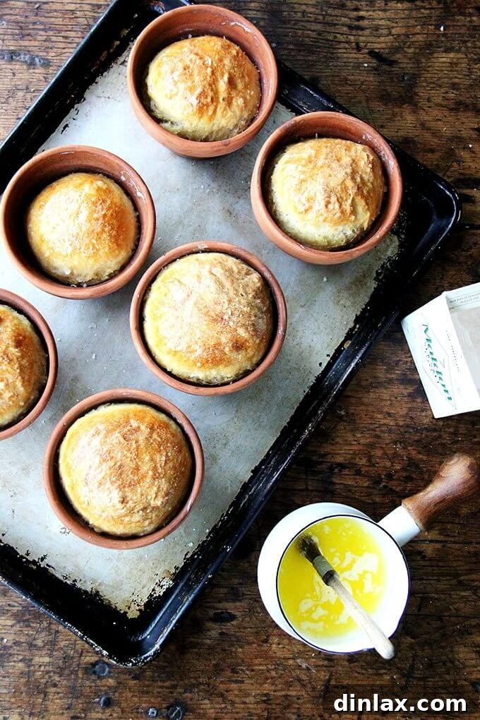 Individual flowerpot bread loaves baking in the oven, with a golden crust forming. // alexandracooks.com