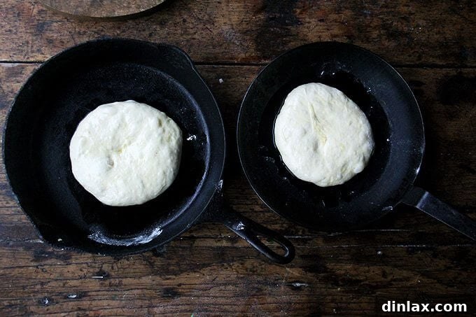 Mastering Skillet Pizza Perfection 11 Two cast iron skillets holding pizza dough.