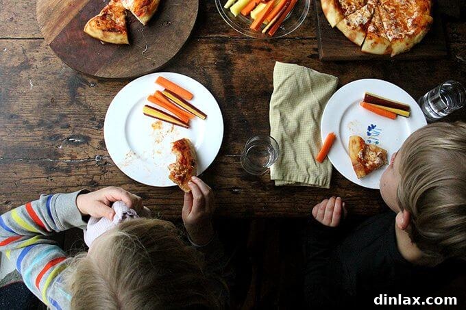Mastering Skillet Pizza Perfection 16 Overhead shot of kids eating skillet pizza and carrots.