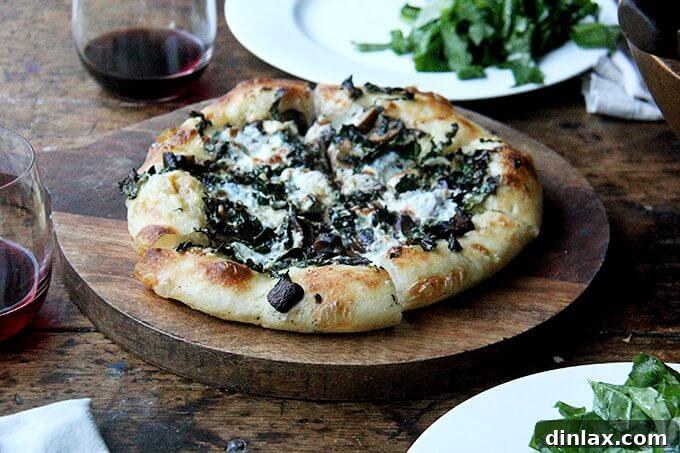 Mastering Skillet Pizza Perfection 19 A kale and mushroom skillet pizza on a board.