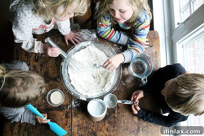 Mastering Skillet Pizza Perfection 3 Overhead shot of children whisking together the pizza dough.