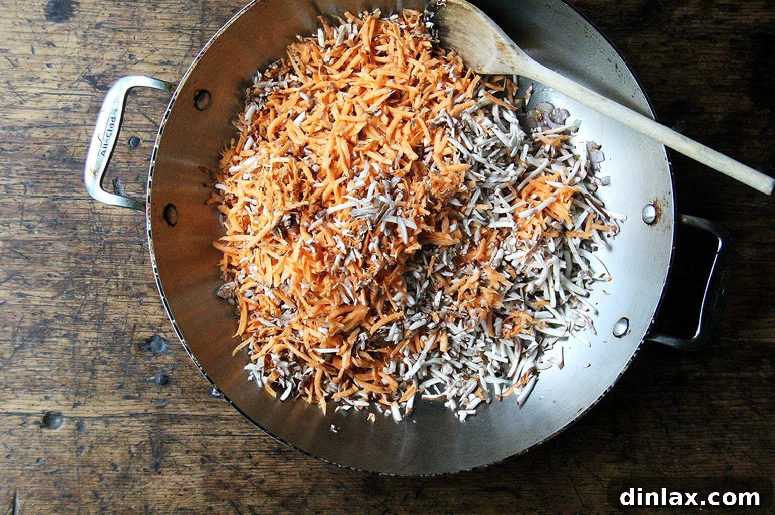 Shredded sweet potatoes and mushrooms gently sautéing in a skillet, their colors deepening as they soften and release their aromatic essences.