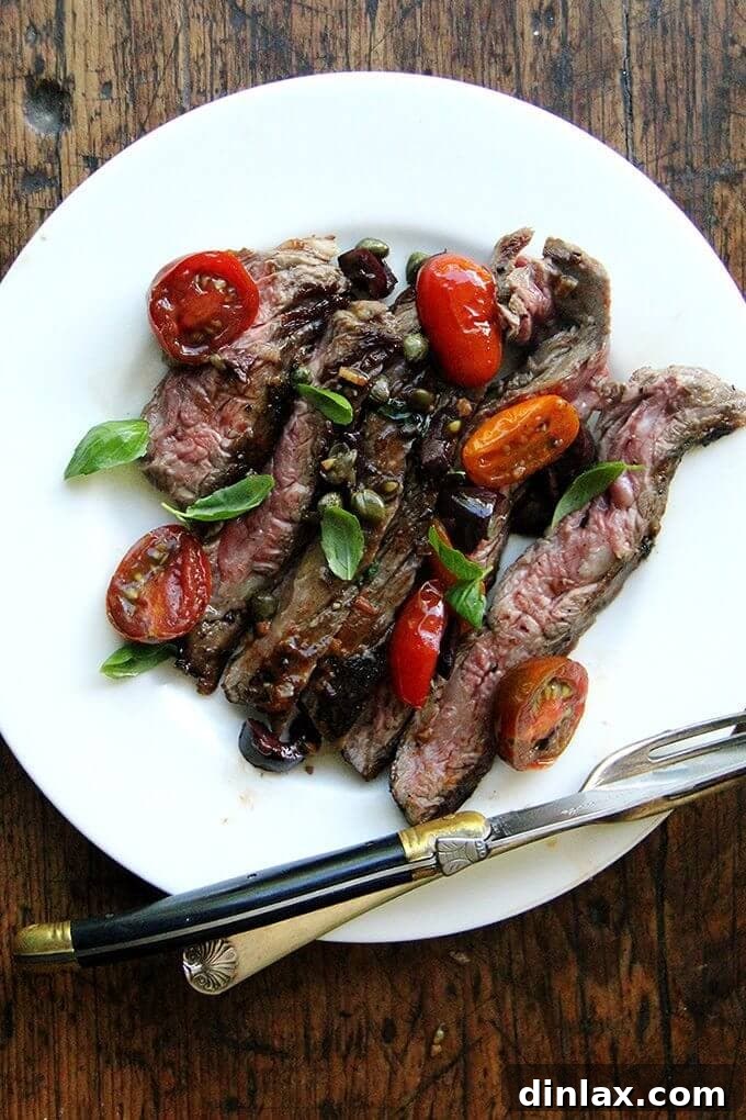 Skirt Steak Nicoise: A Quick and Flavorful Summer Dinner with Tangy Sauce A perfectly seared skirt steak resting, ready to be served with a vibrant, fresh Nicoise sauce made from cherry tomatoes, olives, and capers. This image captures the essence of a delicious, easy-to-make summer meal.