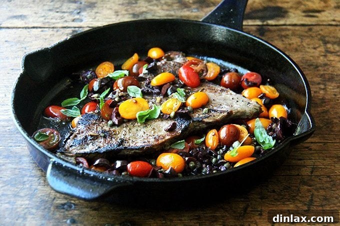 Pan Seared Skirt Steak Nicoise 3 A beautifully presented Skirt Steak Nicoise meal with perfectly sliced steak, vibrant Nicoise sauce generously spooned over, and a side of rustic crusty bread, all elegantly arranged and ready to be savored.