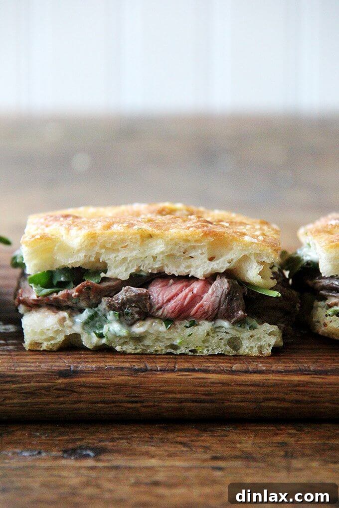 Perfectly seared skirt steak sandwiches with herbed mayonnaise and arugula on focaccia. Delicious skirt steak sandwiches with perfectly seared steak, fresh arugula, and creamy herbed mayonnaise on focaccia bread.