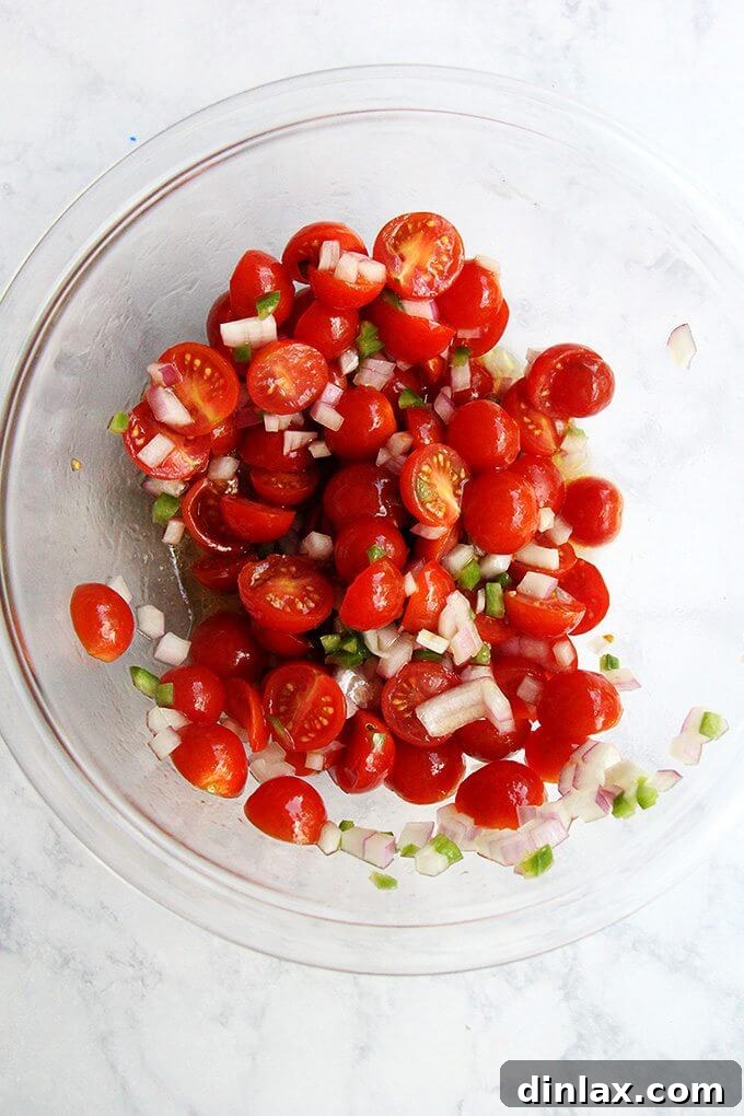 A vibrant bowl of spicy tomato salsa, ready to garnish gazpacho or other dishes. a bowl of tomato salsa