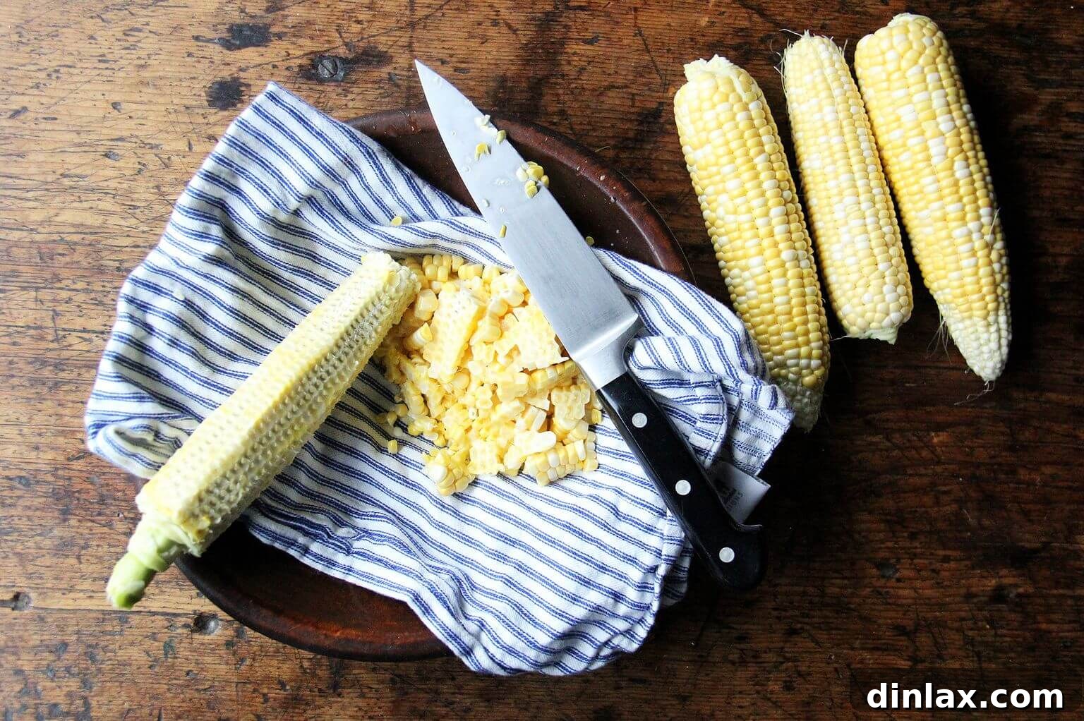 Deborah Madison's Creamy Curried Coconut Corn Soup 3 A deep bowl lined with a white tea towel, filled to the brim with freshly stripped corn kernels, showcasing the vibrant yellow.