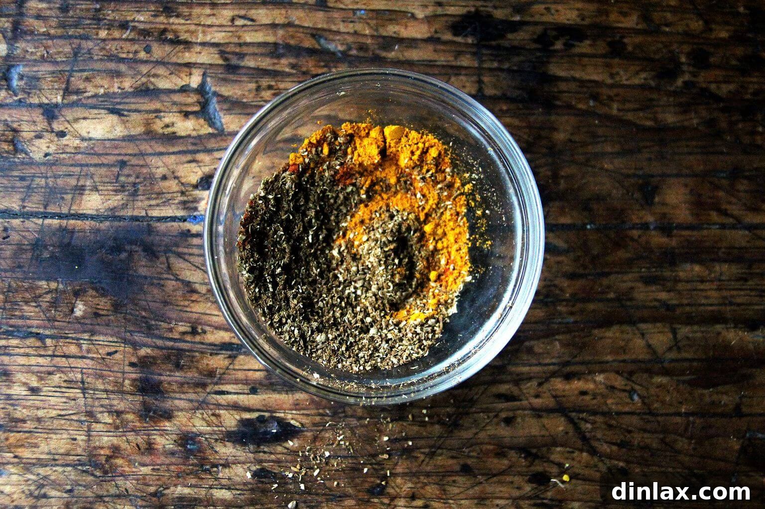 Deborah Madison's Creamy Curried Coconut Corn Soup 6 A small, elegant white bowl filled with a colorful blend of aromatic curry spices, finely ground and ready for use.