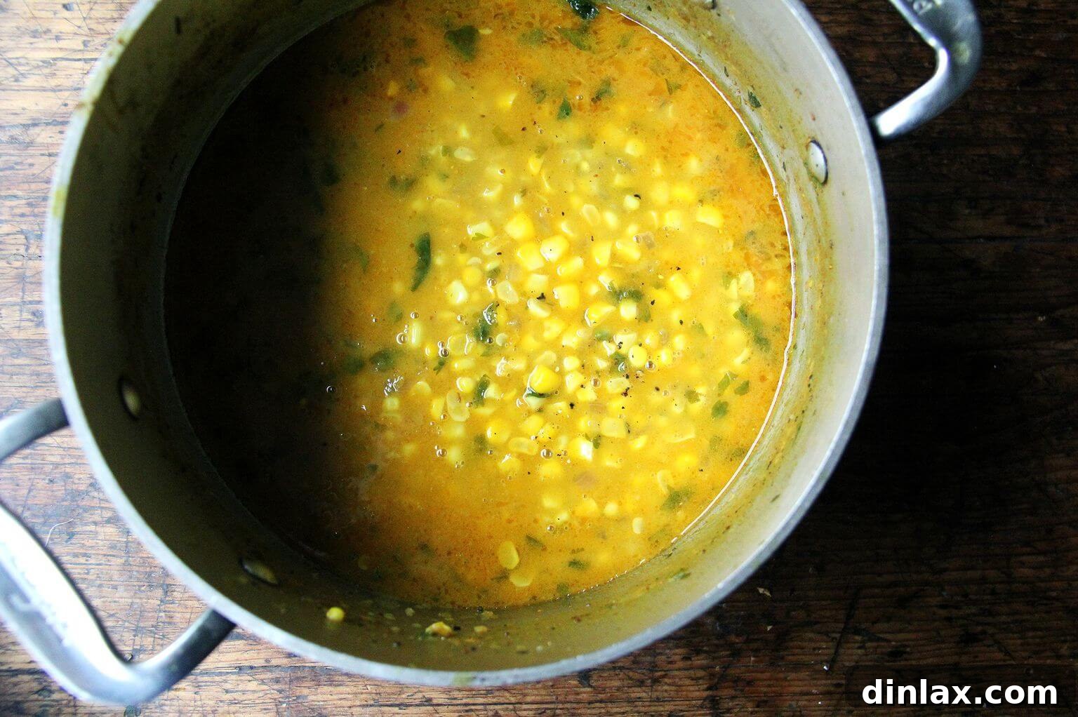 Deborah Madison's Creamy Curried Coconut Corn Soup 9 A simmering pot of fragrant curried coconut corn soup, its creamy texture and rich color promising a comforting meal.