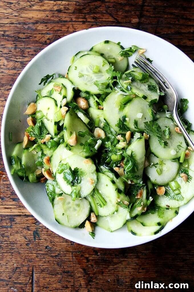 A vibrant bowl of Vietnamese cucumber salad, garnished with fresh herbs and peanuts, ready to be enjoyed.