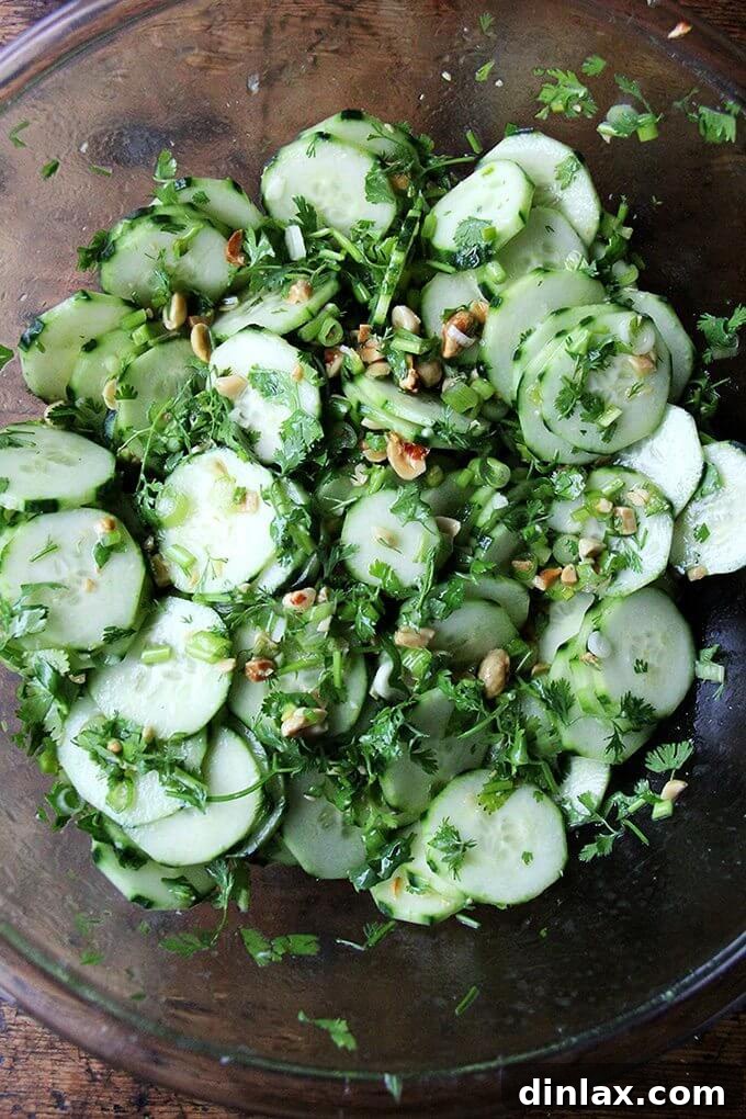 A large bowl of Samin Nosrat's Vietnamese cucumber salad, fully tossed and ready to serve, showcasing the refreshing blend of ingredients.