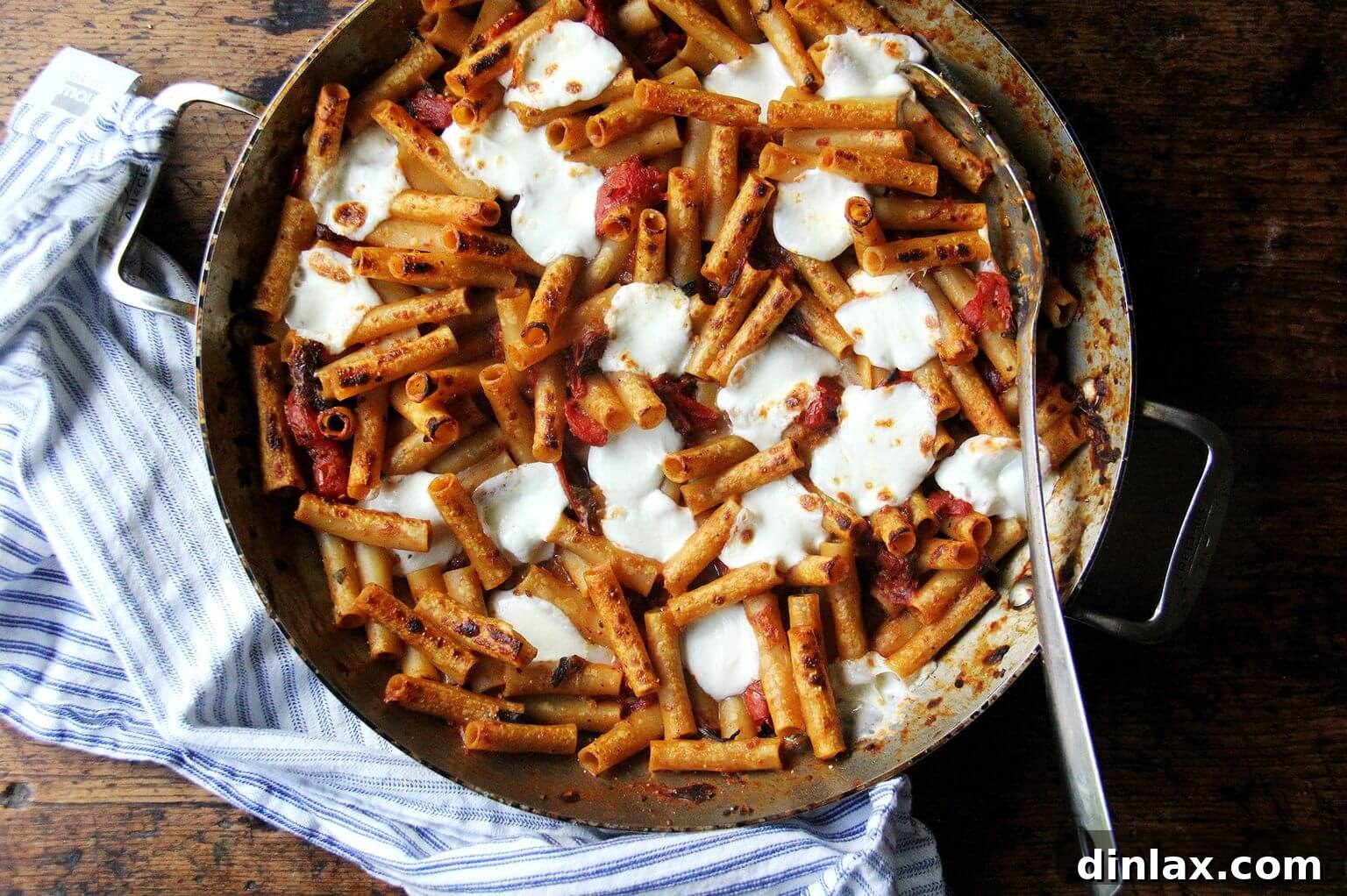 The finished one-pan baked ziti in a large skillet, fresh from the broiler with perfectly melted, bubbly, and slightly browned mozzarella.