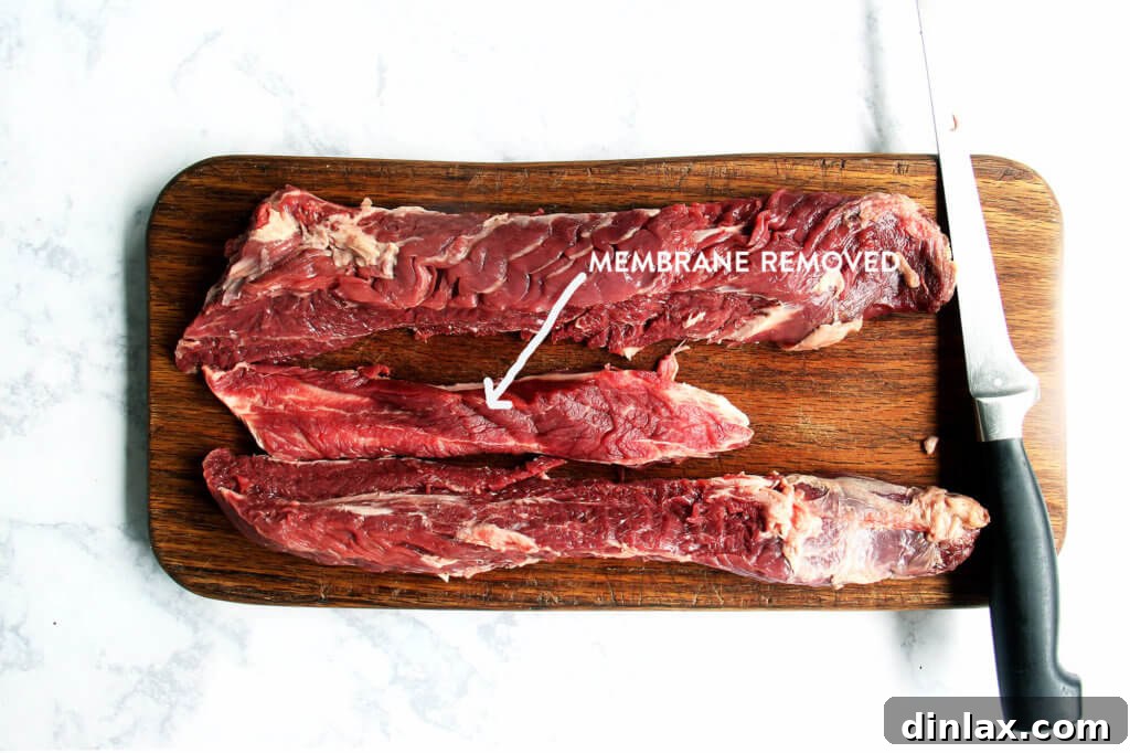 Close-up of fresh thyme sprigs and garlic cloves, key ingredients for the flavorful hanger steak marinade.