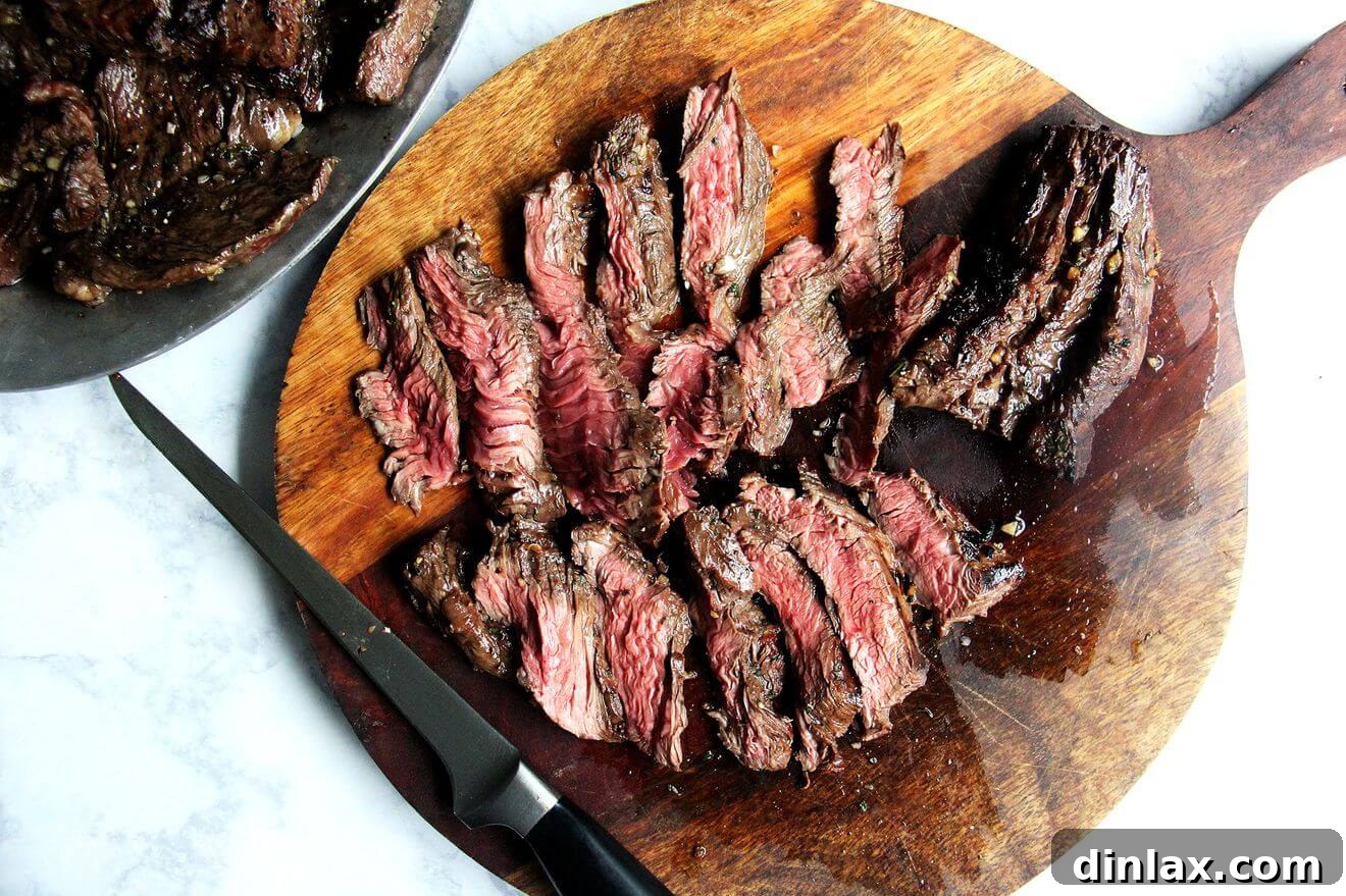 Sliced hanger steak arranged on a cutting board, ready to be served.