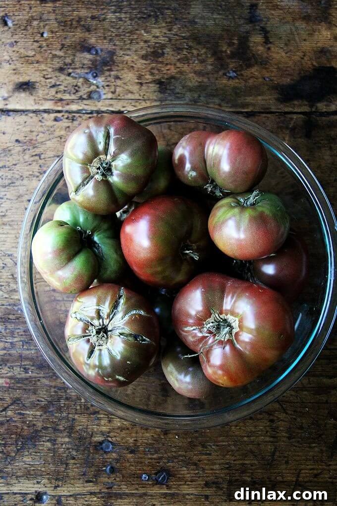 Marcella Hazan's Effortless Butter and Onion Tomato Sauce 3 A vibrant bowl filled with fresh, ripe garden tomatoes, ready for making homemade sauce.