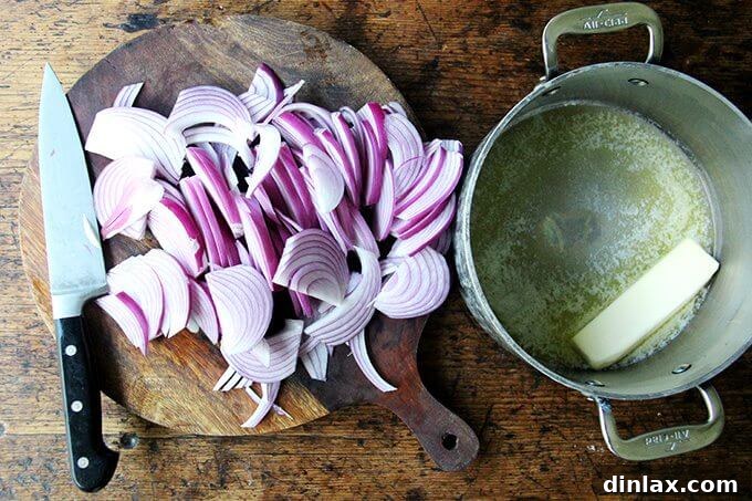 Marcella Hazan's Effortless Butter and Onion Tomato Sauce 5 A board of thinly sliced onions aside a pot with melted butter and onions beginning to cook.