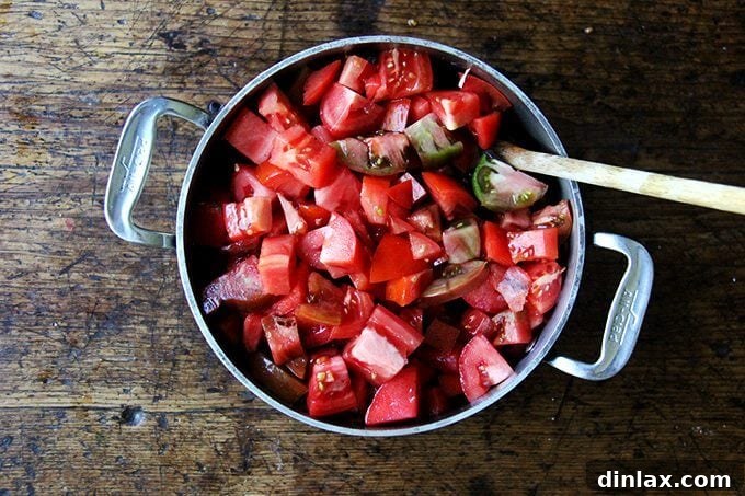 Marcella Hazan's Effortless Butter and Onion Tomato Sauce 9 A pot with simmered onions and chopped tomatoes heaped on top, ready to be stirred.